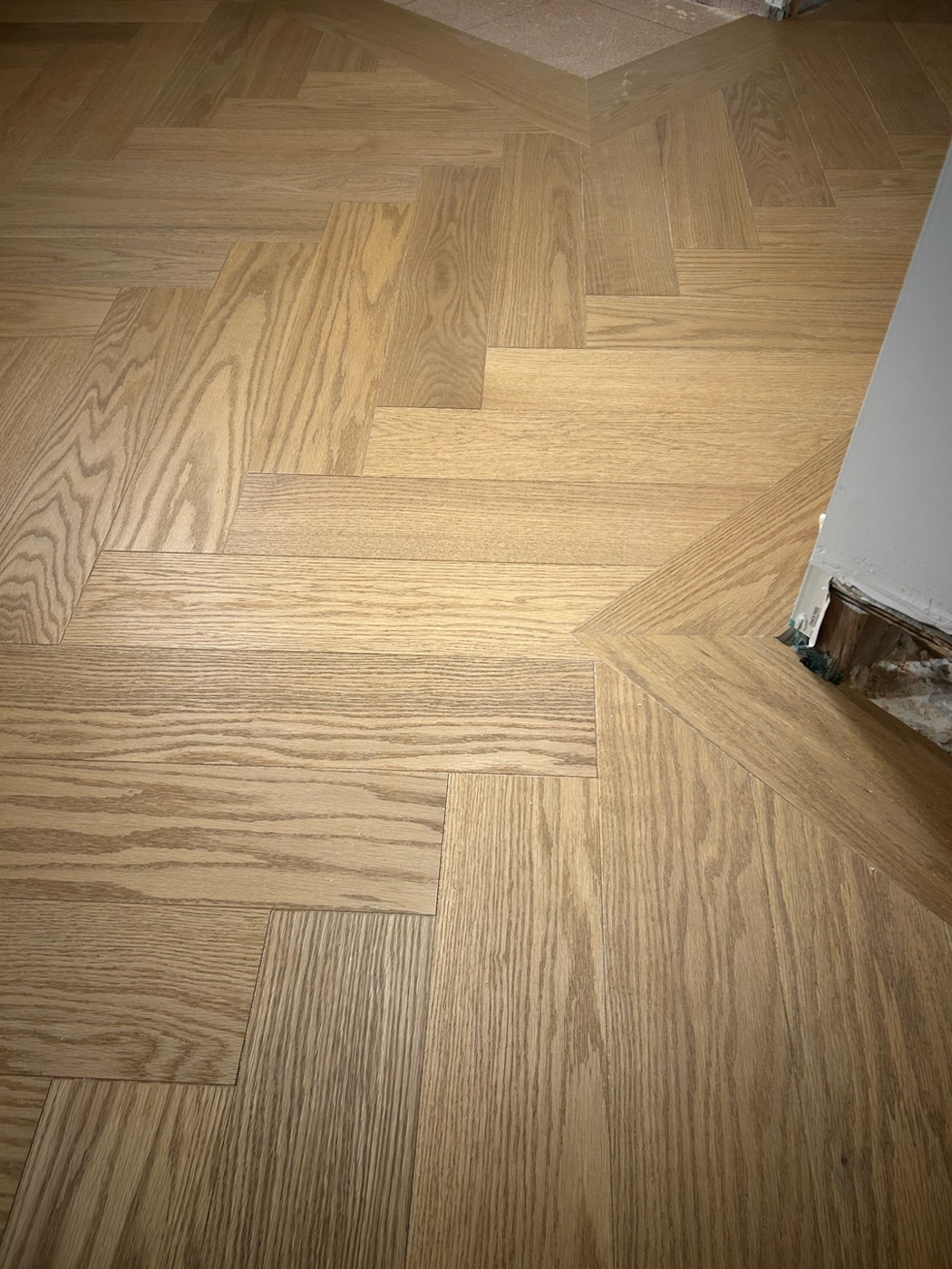 Close detail of hardwood flooring with a flush floor vent cutout