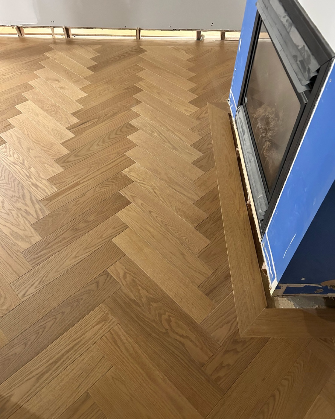Hardwood flooring with precise flush detail and finished edge
